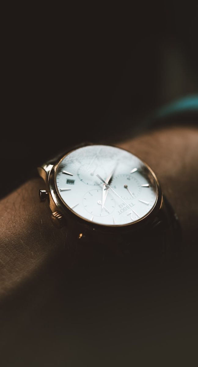 person wearing white chronograph watch